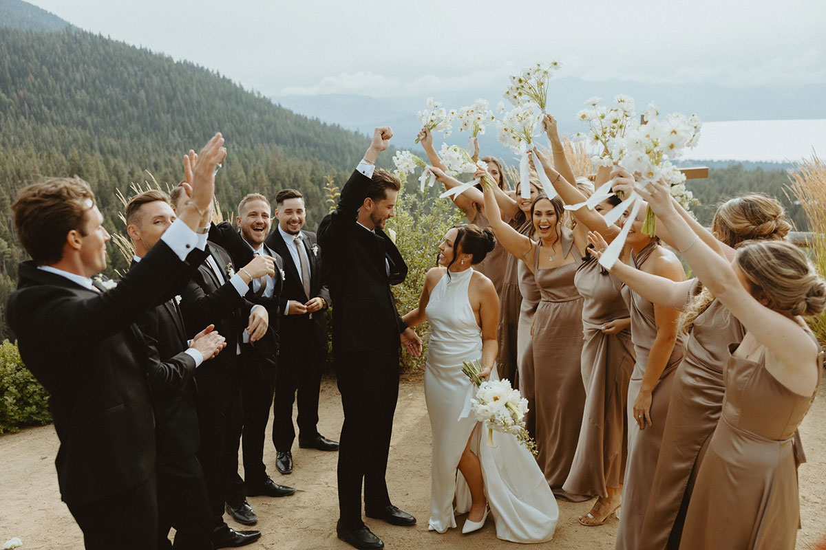 Bride and groom celebrating with joyful wedding party after ceremony at Lake Tahoe, captured during a beautifully coordinated day by Events by Justine