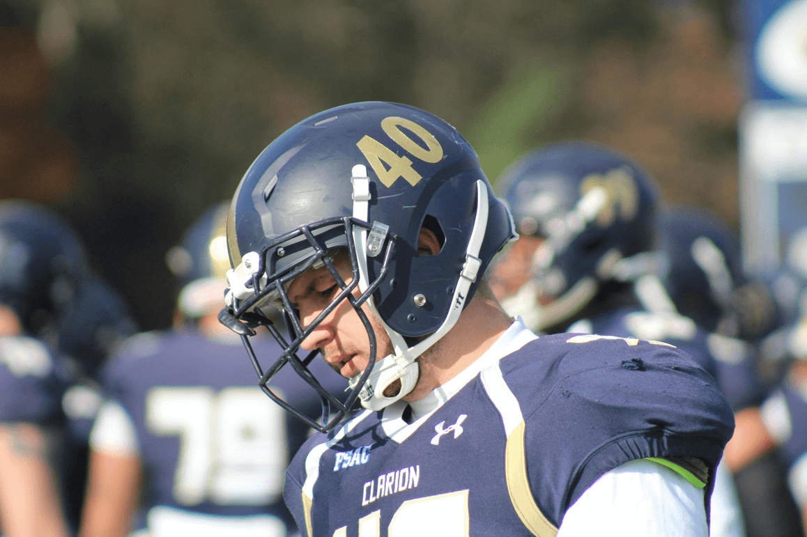 A high school football player wearing a helmet during a game of football in Atlanta, GA