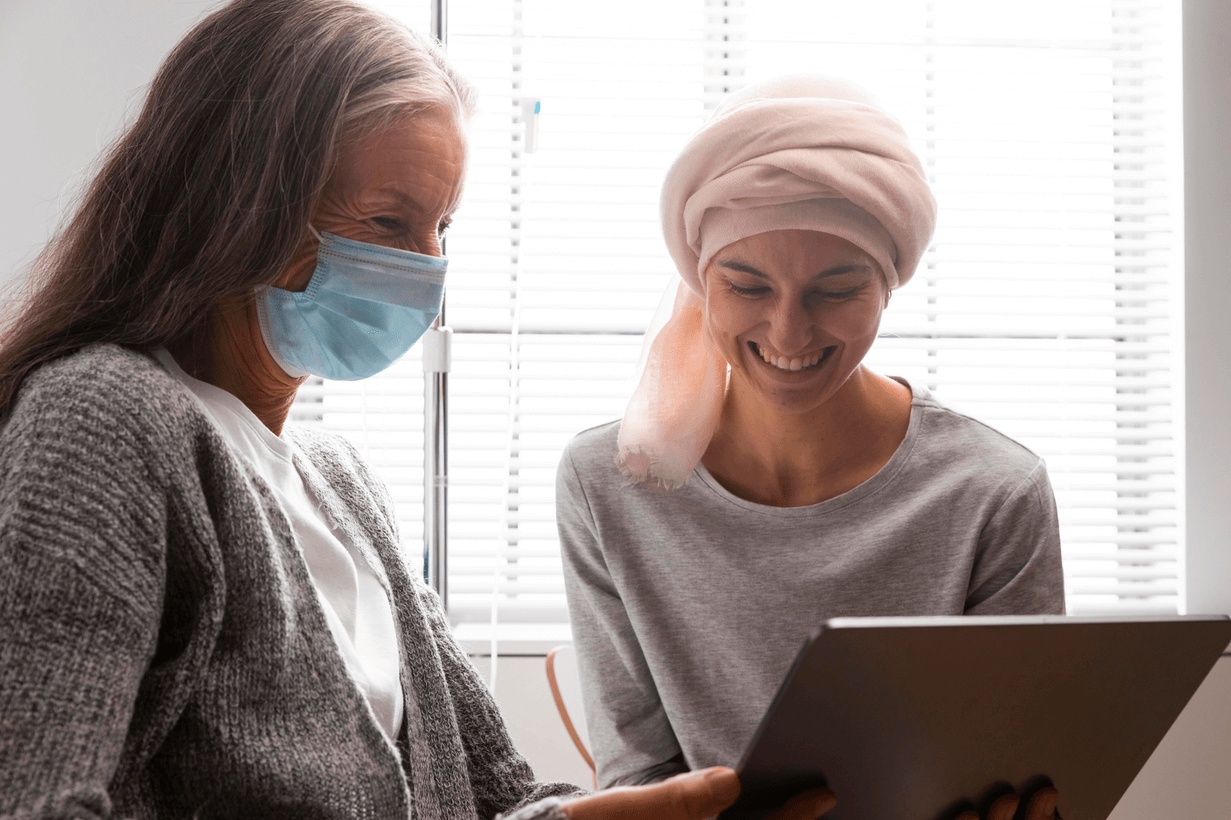Two women smiling during recovery and supportive care while exploring hyperbaric oxygen for radiation injury.
