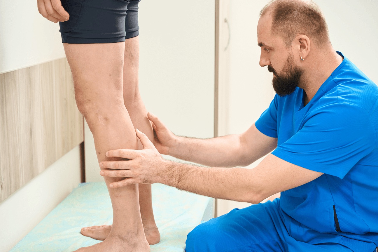 Medical specialist examining a patient’s lower leg for a severe leg infection, highlighting evaluation and care options including the best HBOT for necrotizing tissue infection to support healing and recovery.