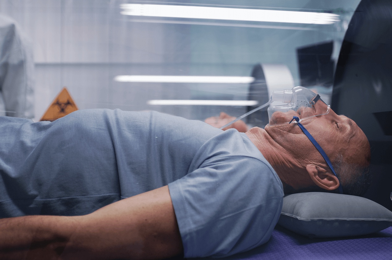 Patient receiving hyperbaric oxygen therapy in Cumming, GA, lying comfortably in an accredited hyperbaric chamber with an oxygen mask as part of advanced treatment to promote healing and recovery.