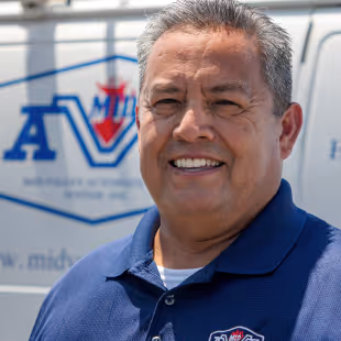 A photo of John Martinez Jr. smiling.