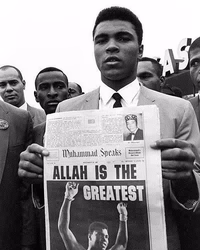 Muhammad Ali holding newspaper