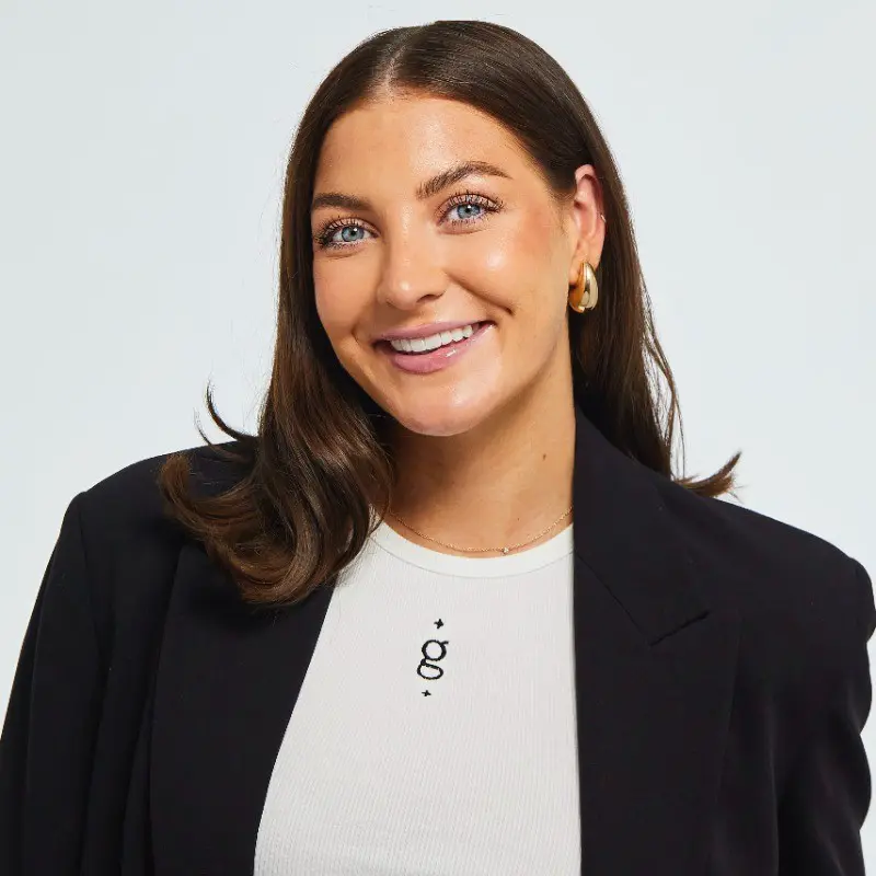 A woman wearing a white shirt and a black jacket.