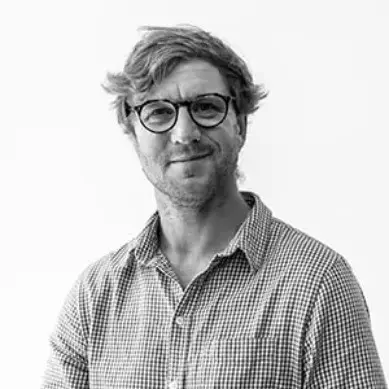 A man wearing glasses and a plaid shirt.