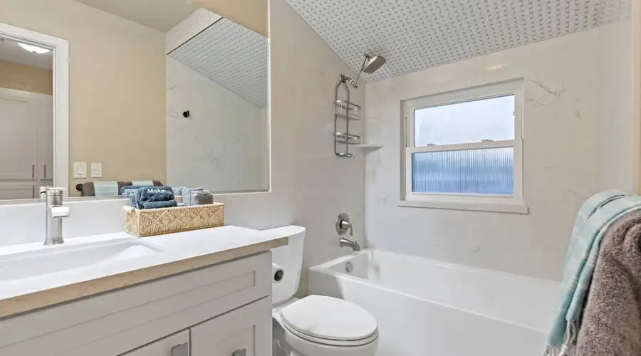 Discover the charm of this spacious residence boasting a beautifully updated kitchen and bathrooms, wet bar with wine fridge, custom made barn doors, while having the convenience of a 1st floor bedroom and bathroom with side access to the pool area. The in