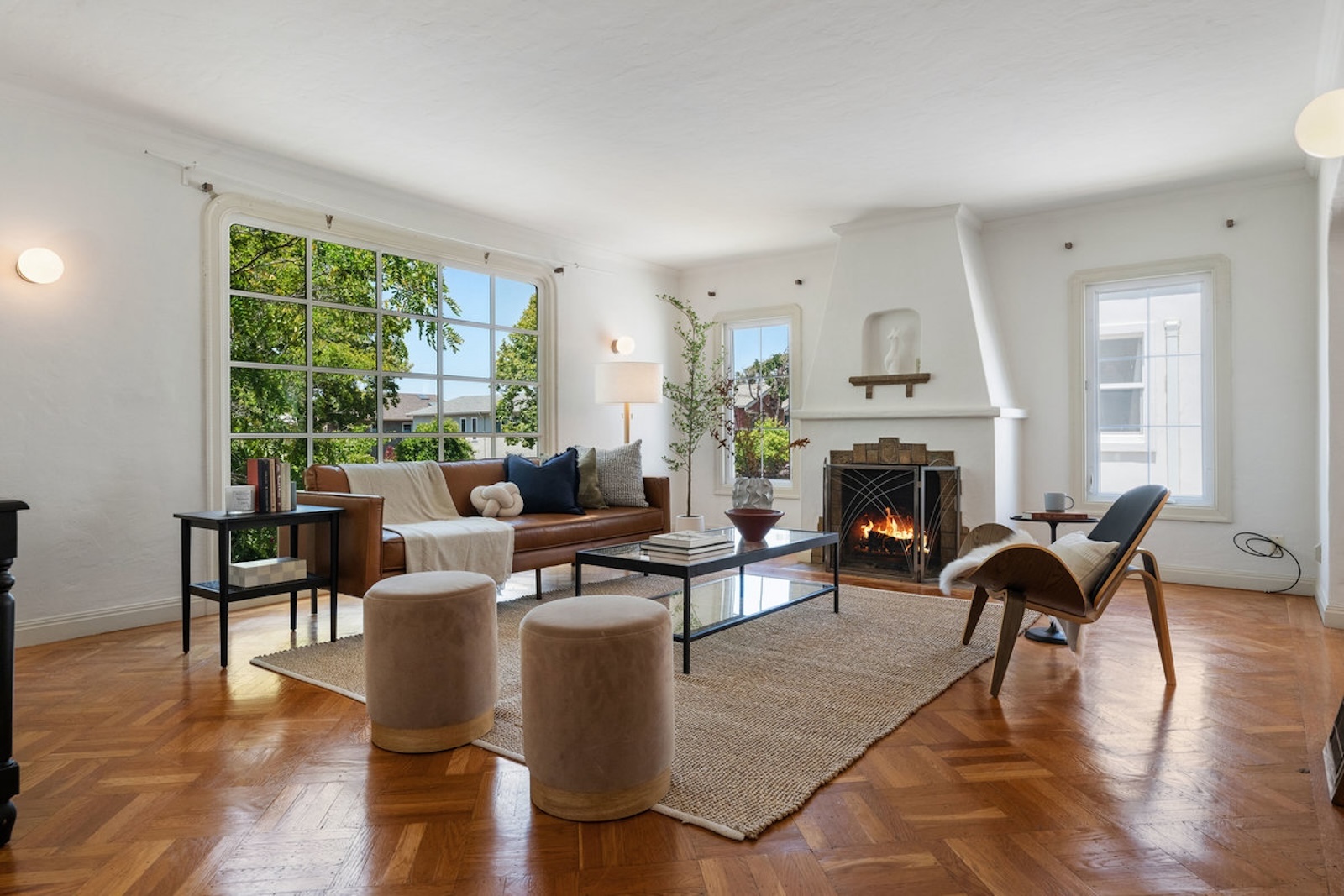 Light-filled living room with fireplace staged by Only Stagers