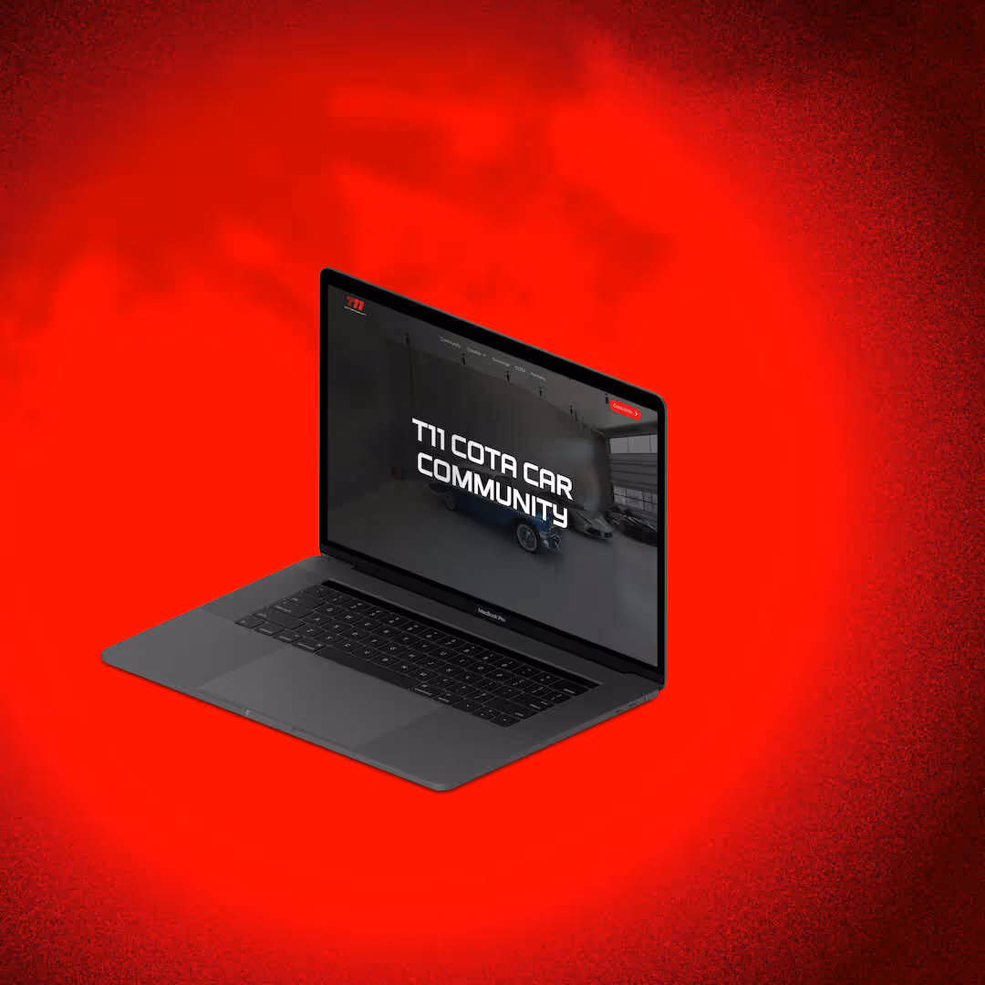 Open MacBook Pro laptop displaying a website homepage with text 'T11 Cota Car Community' on a red gradient background.