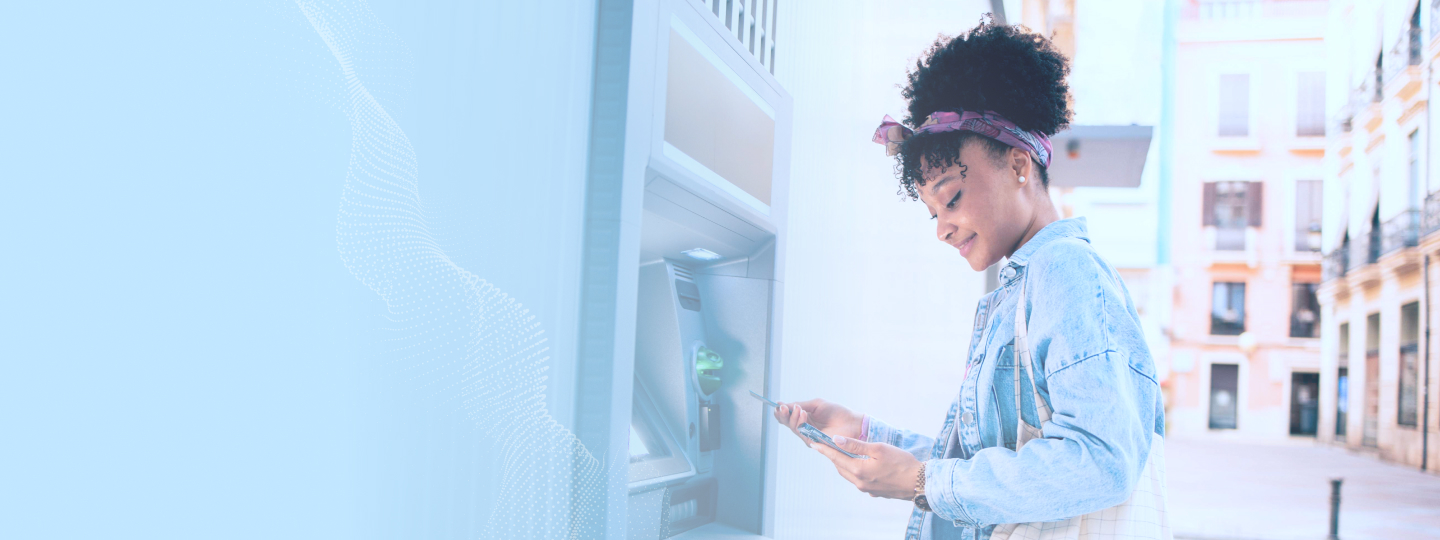 Adult woman using ATM