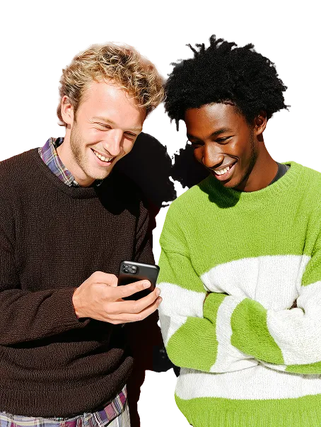Two young men looking down to a phone.