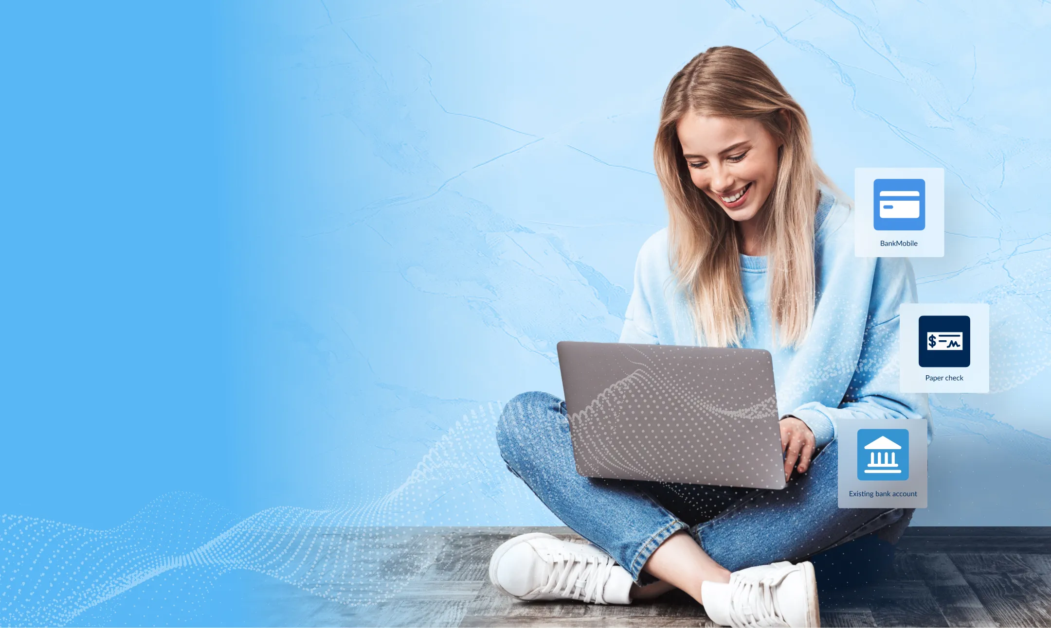 Student female sitting crosslegged on the floor with her laptop in her lap