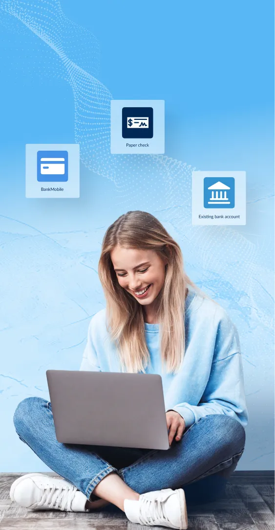 Student female sitting crosslegged on the floor with her laptop in her lap