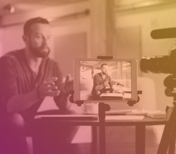 Young adult male making a video on his computer