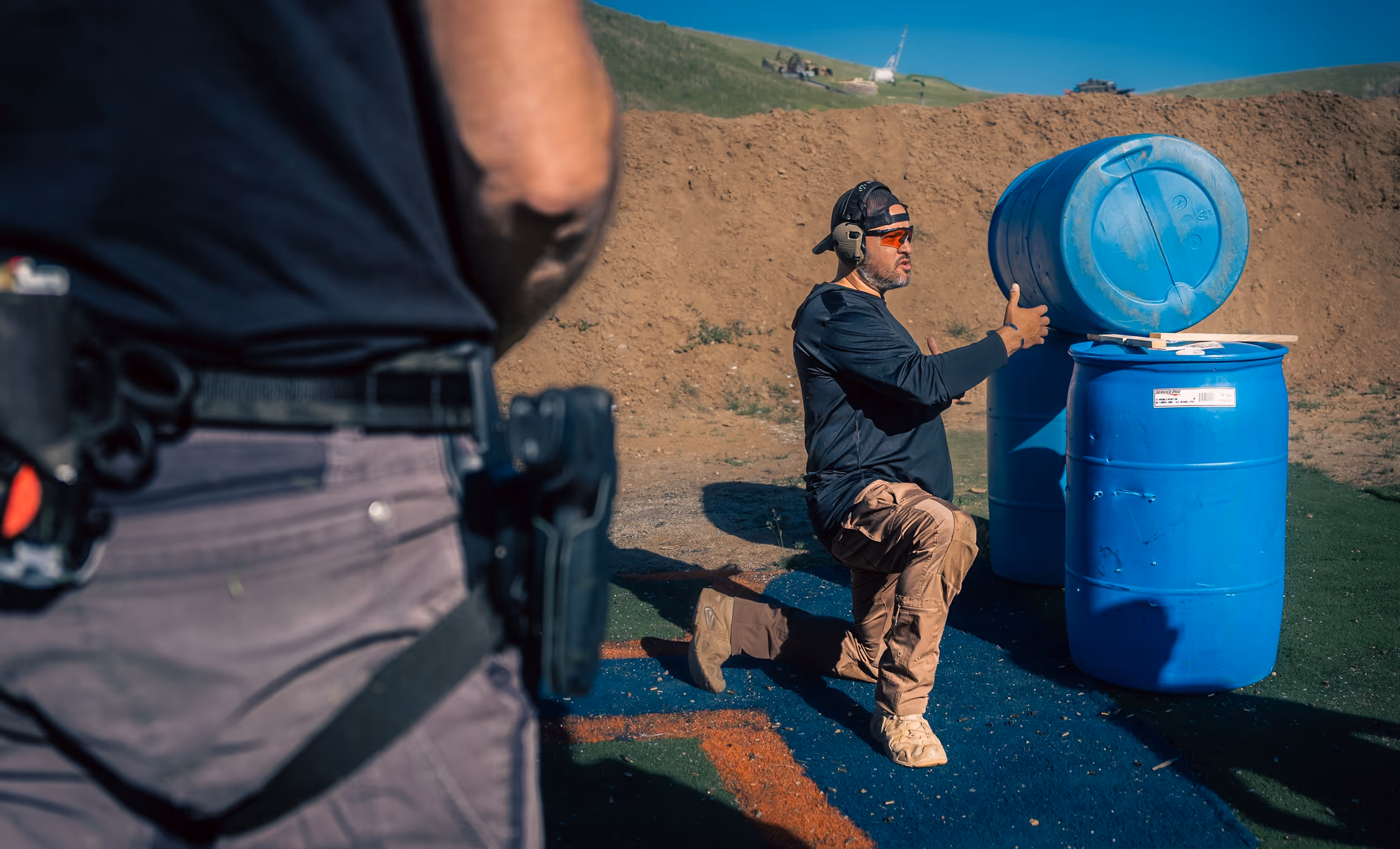 Founder and Special Operations veteran Nate Castillo instructs a private small group during firearms training in the Boise, Idaho foothills, demonstrating movement and cover techniques.