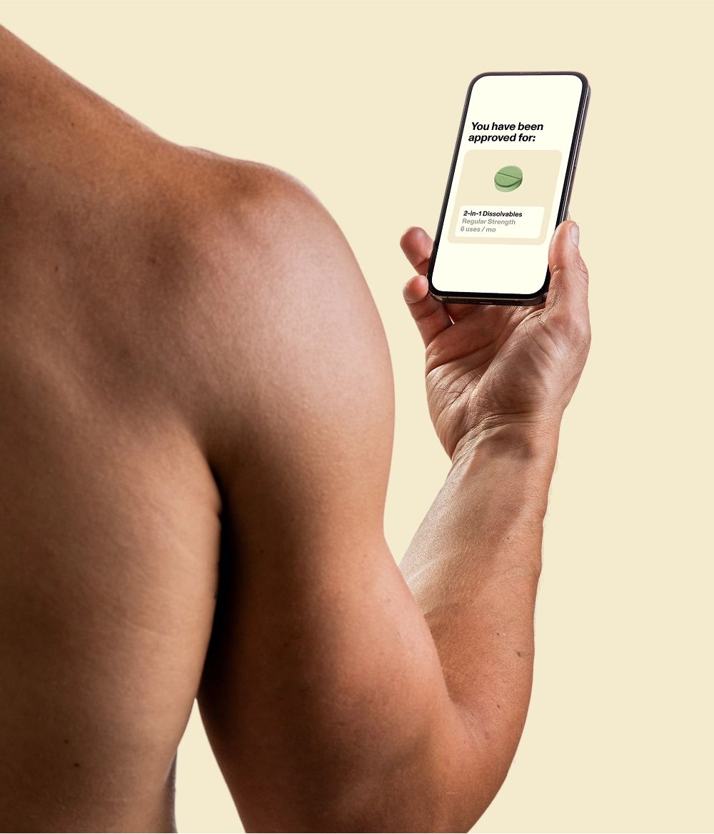Shirtless man holding phone displaying a message that reads ‘You have been approved for: 2-in-1 Dissolvables’
