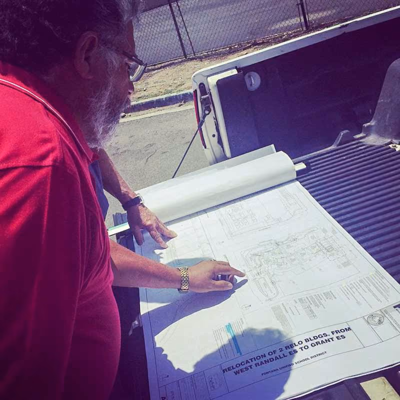 Reviewing site plans on a truck tailgate