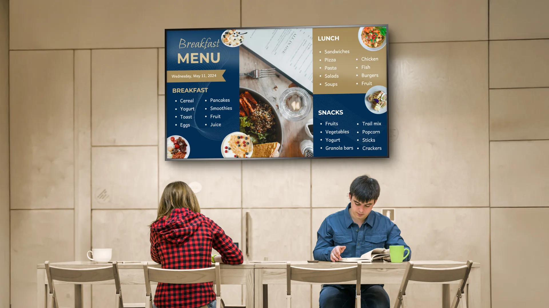 Students at a table with a digital menu board in a cafeteria behind them.
