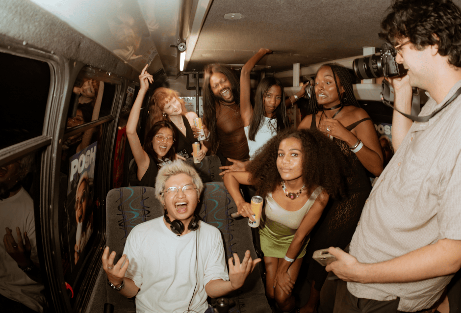 Laughing friends partying together packed inside a van interior