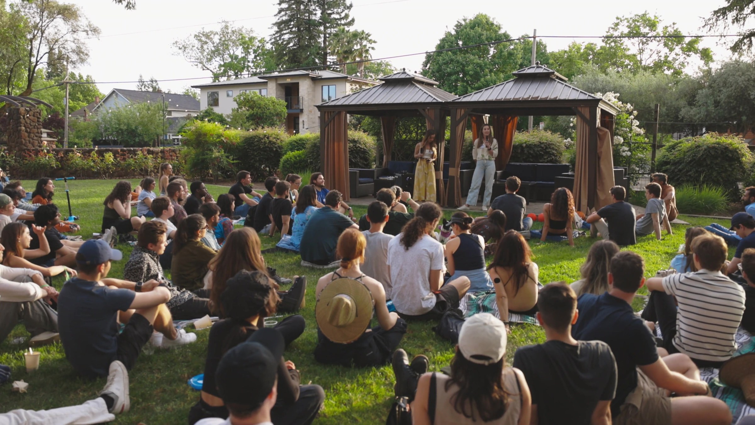 A crowd seated outdoors for a talk at Edge Esmeralda