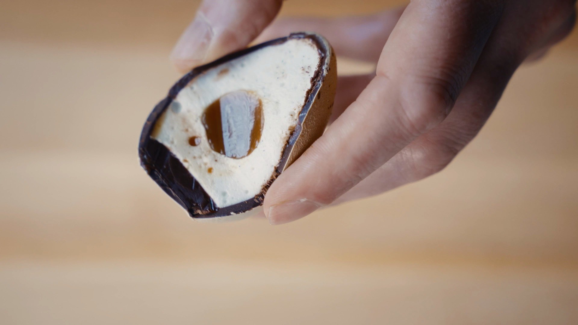A hand holding the cracked Signature Easter Egg