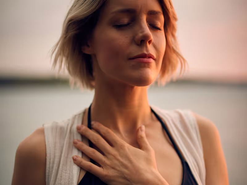 Woman with hand on heart