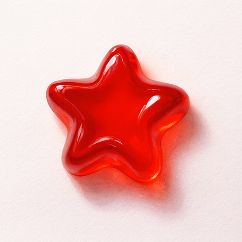 Glossy red star-shaped gummy candy on a white surface.