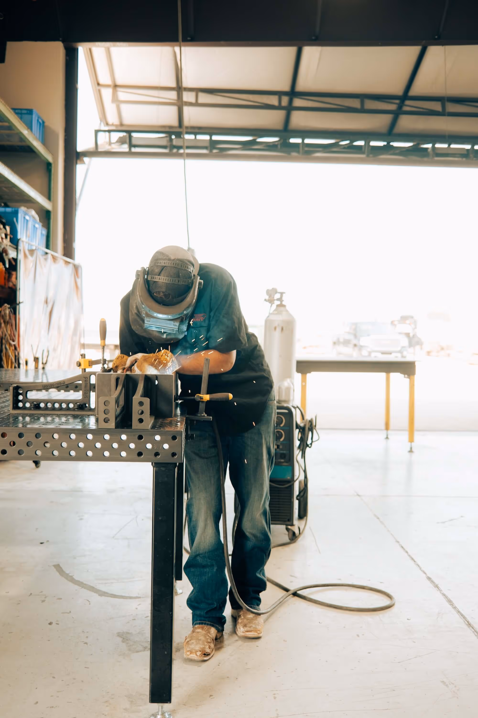 Flight Fabrication team member working on a piece of metal
