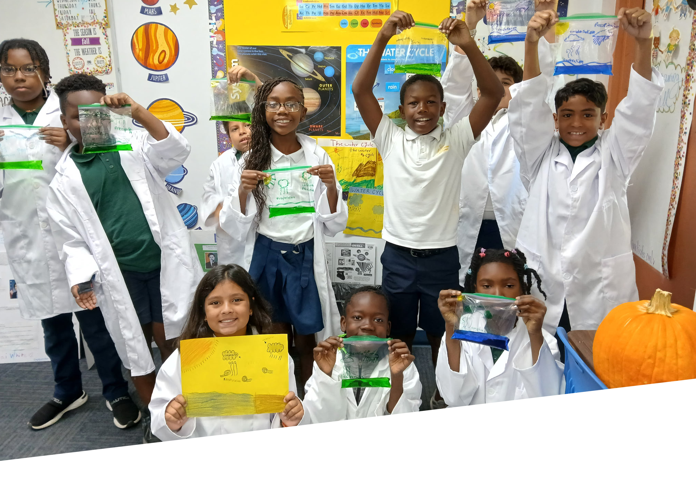 5th grade students in a classroom holding water cycle experiment bags during a science lesson