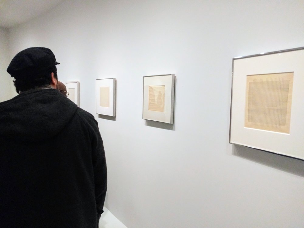 DSVA student Milos Zahradka Maiorana examining some of Martin’s drawings, Guggenheim, 2017. Photo by Jonathan Morgan