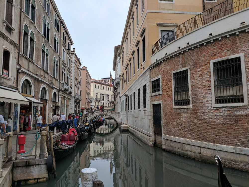 People walking along one of Venice's many canals Photo Credit: Jonathan Morgan