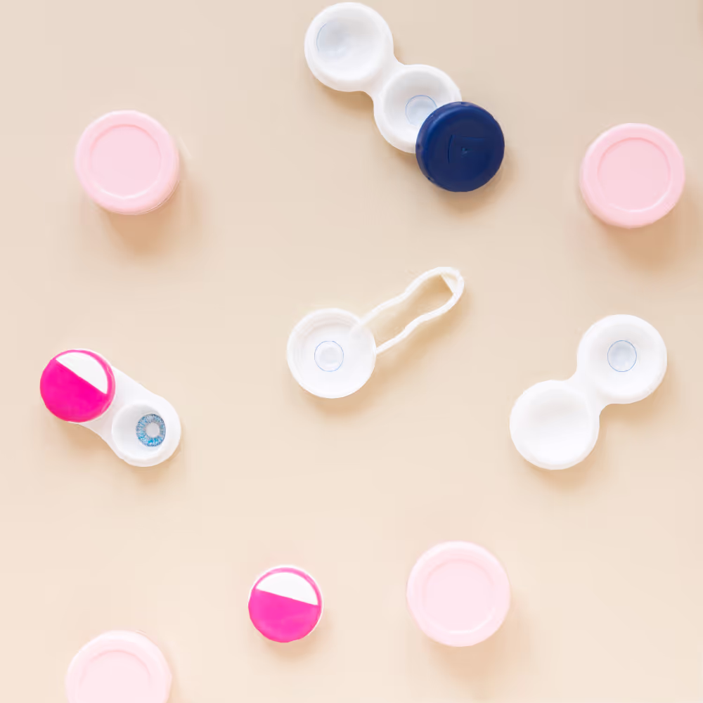 Contact lens cases and containers in pastel pink, white, and blue colors