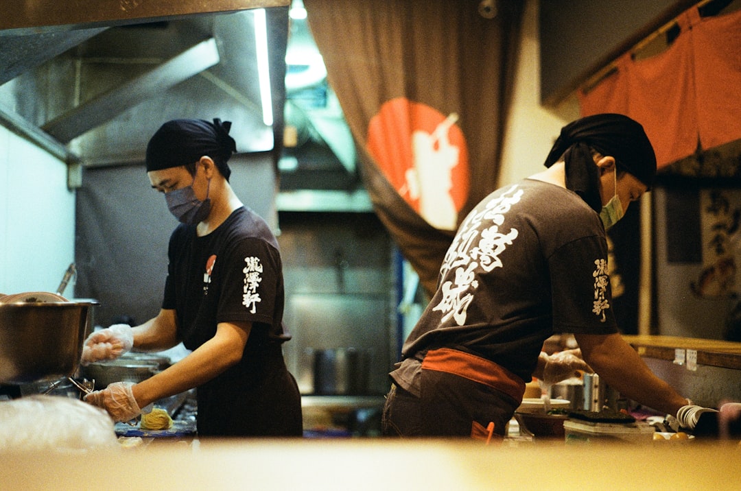 restaurant staff teamwork a couple of men standing in a kitchen preparing food