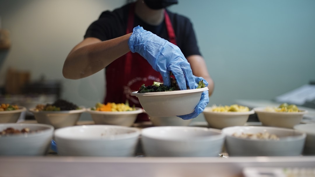 Woman prepping food, chef in restaurant kitchen preparing a dish