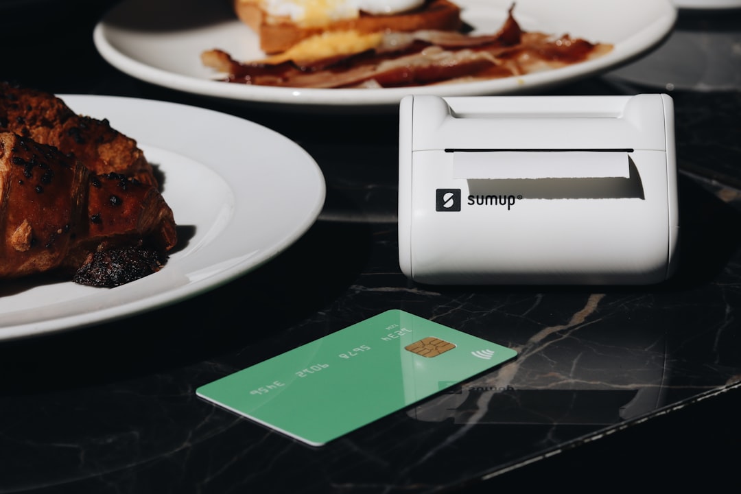 A table topped with plates of food and a credit card, demonstrating integrated restaurant POS technology