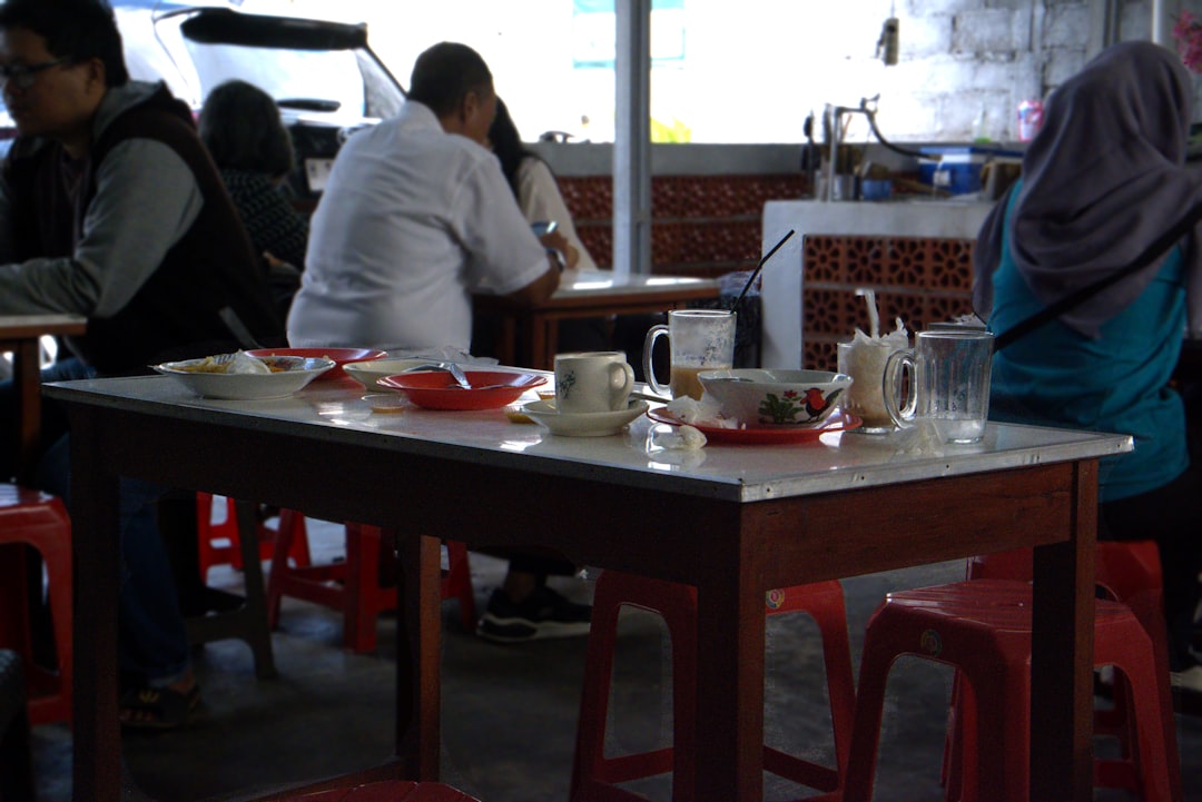 a group of people sitting at a table in a restaurant enjoying dining experience