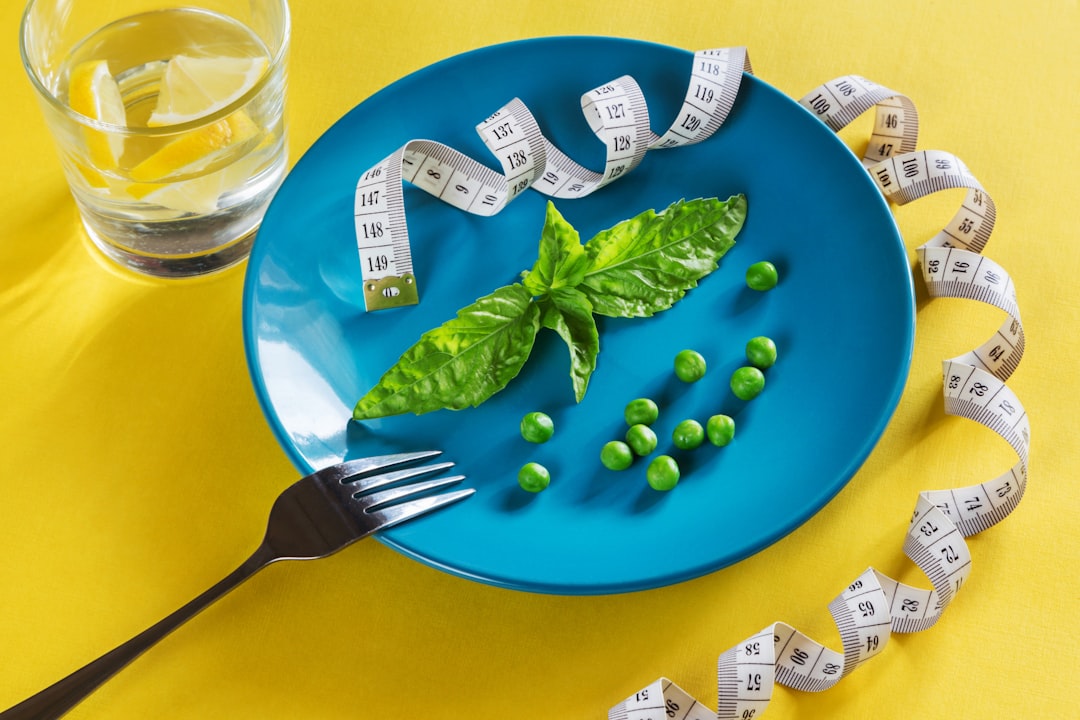 A blue plate topped with green vegetables and a measuring tape, representing health-focused and sustainable food marketing.