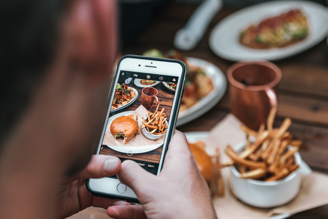 Silver-colored iPhone 6 with black case, representing social media engagement for restaurants