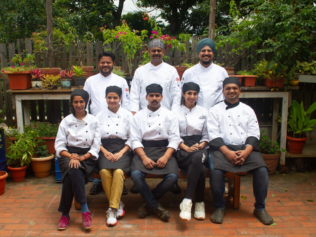 A group of chefs posing for a picture representing restaurant team leadership