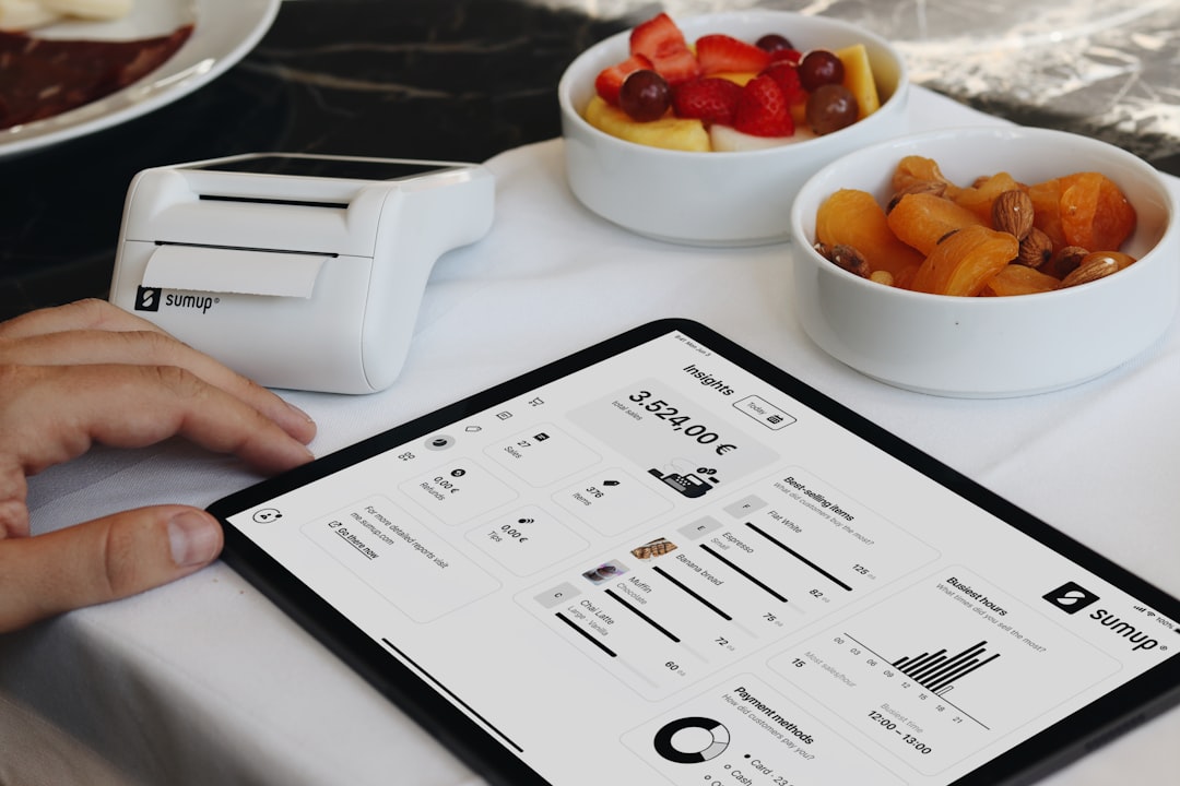 A person using a tablet POS system for restaurant management