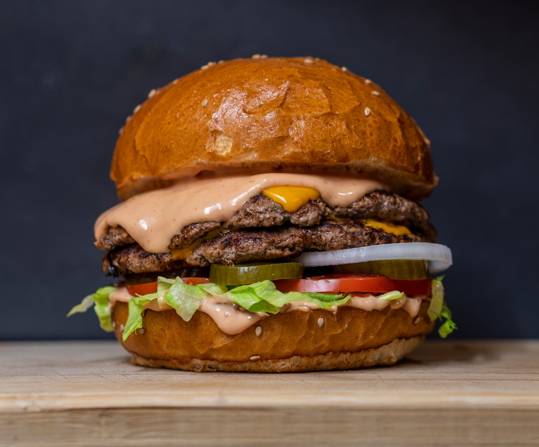 burger with lettuce and tomatoes demonstrating strong restaurant food photography