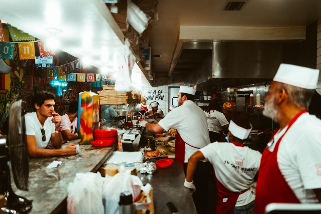 Kitchen staff preparing dishes in a commercial kitchen – illustrating recipe-level tracking and ingredient usage tied to POS transactions