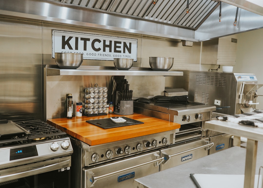 Modern commercial kitchen with stainless steel equipment and prep counters