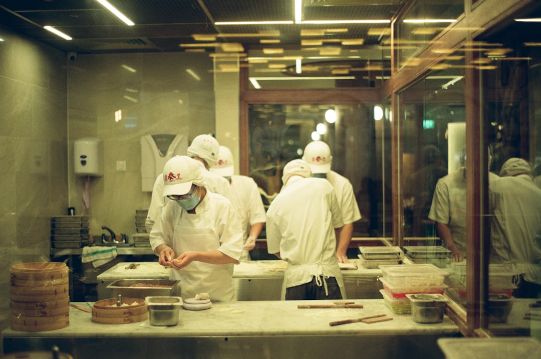 Kitchen staff prepping food in a commercial kitchen during dinner shift