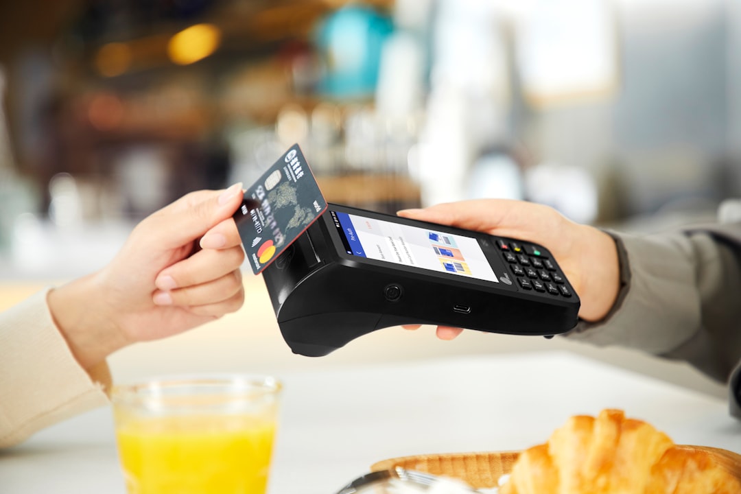 Contactless digital payment with a smartphone-sized terminal at a restaurant table
