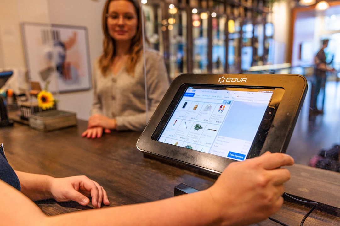 Staff member using a tablet POS at the counter in a modern restaurant