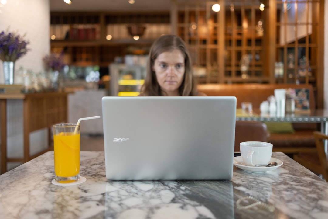 Manager reviewing POS reports on a laptop during a weekly analytics review in a café setting