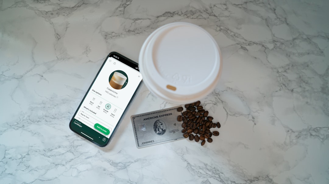 Customer using a coffee shop loyalty app to scan and redeem rewards
