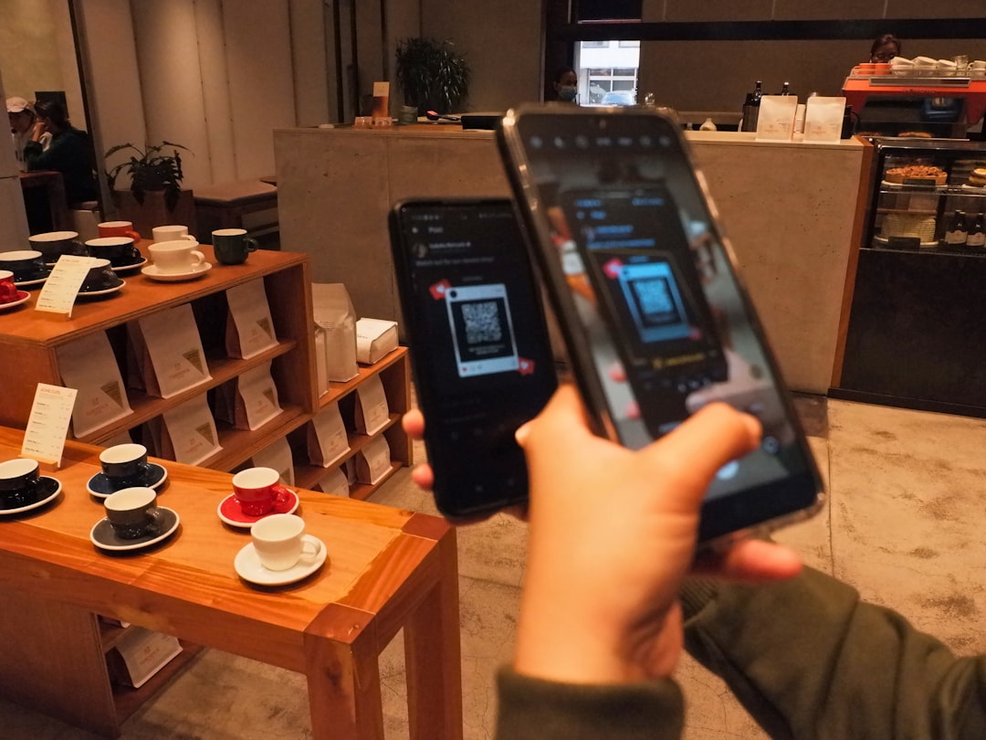 Customer scanning a QR code at a cafe counter for ordering or loyalty enrollment