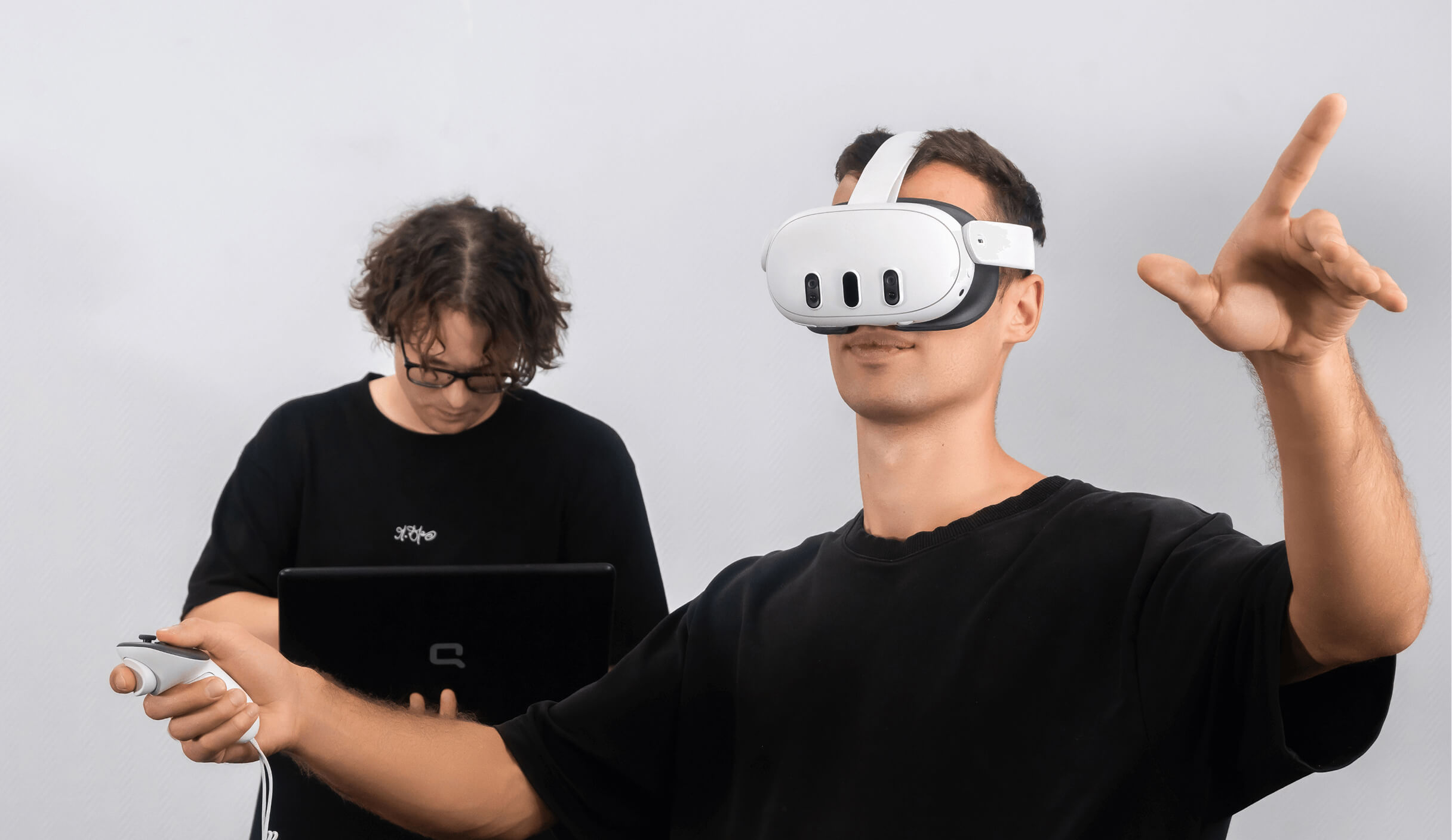 Two people using a VR headset to review a 3D space.