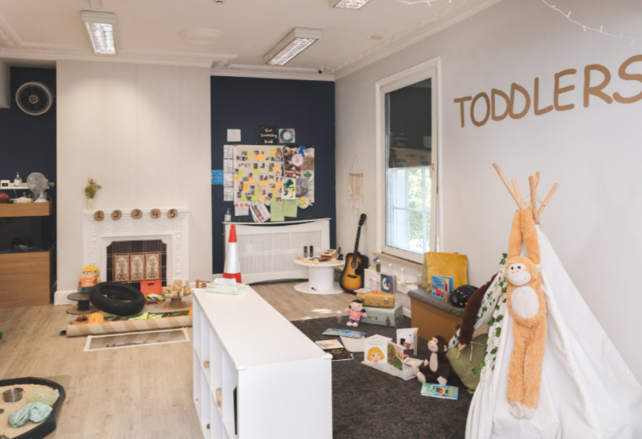 Early years indoor learning activity in a childcare setting with a young child and an adult engaged in table‑top play using wooden peg figures, nurseries in birmingham, day nurseries in birmingham, 30 hours free childcare, 15 hours free childcare   